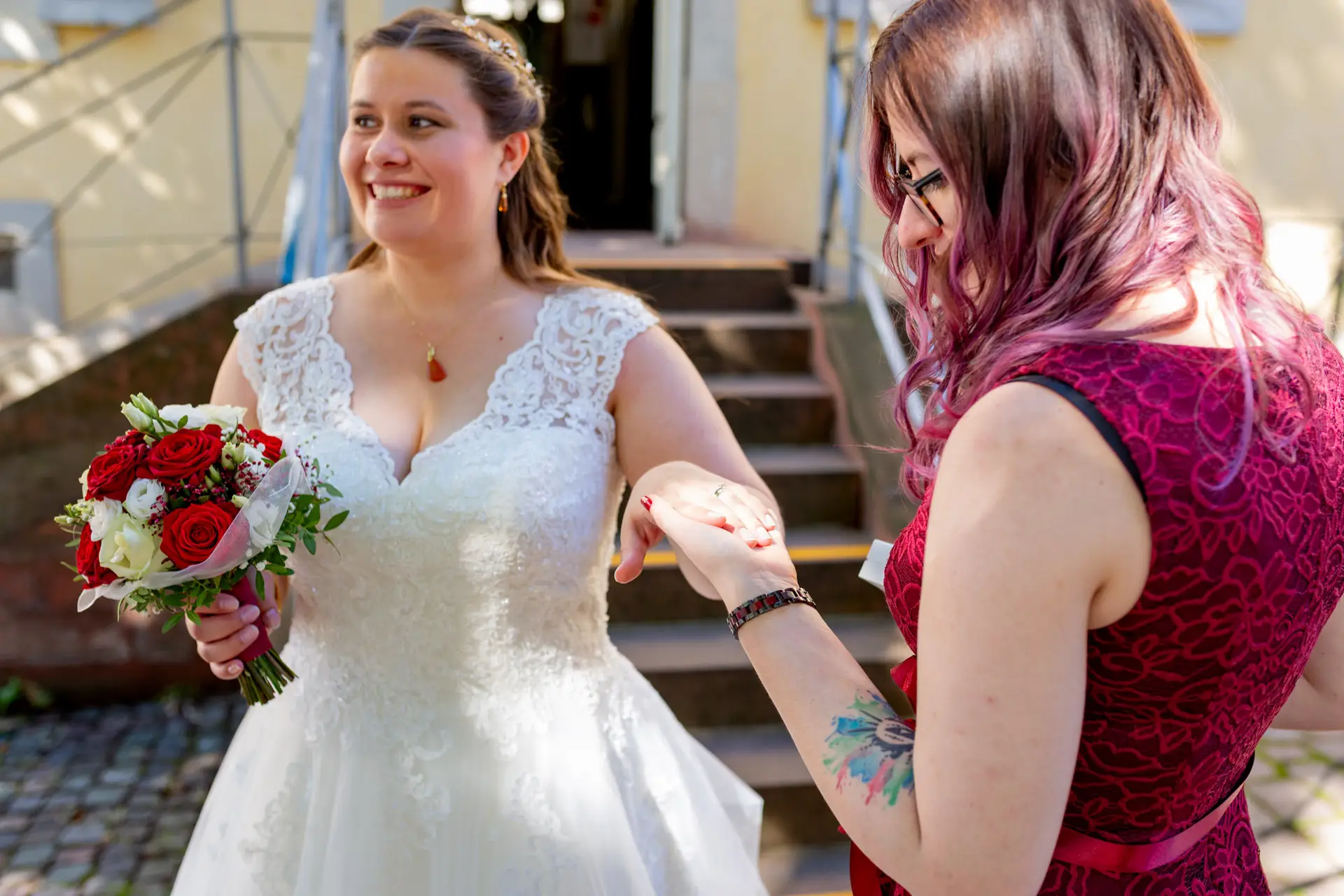 Braut mit Trauzeugin auf den Stufen vor dem Standesamt