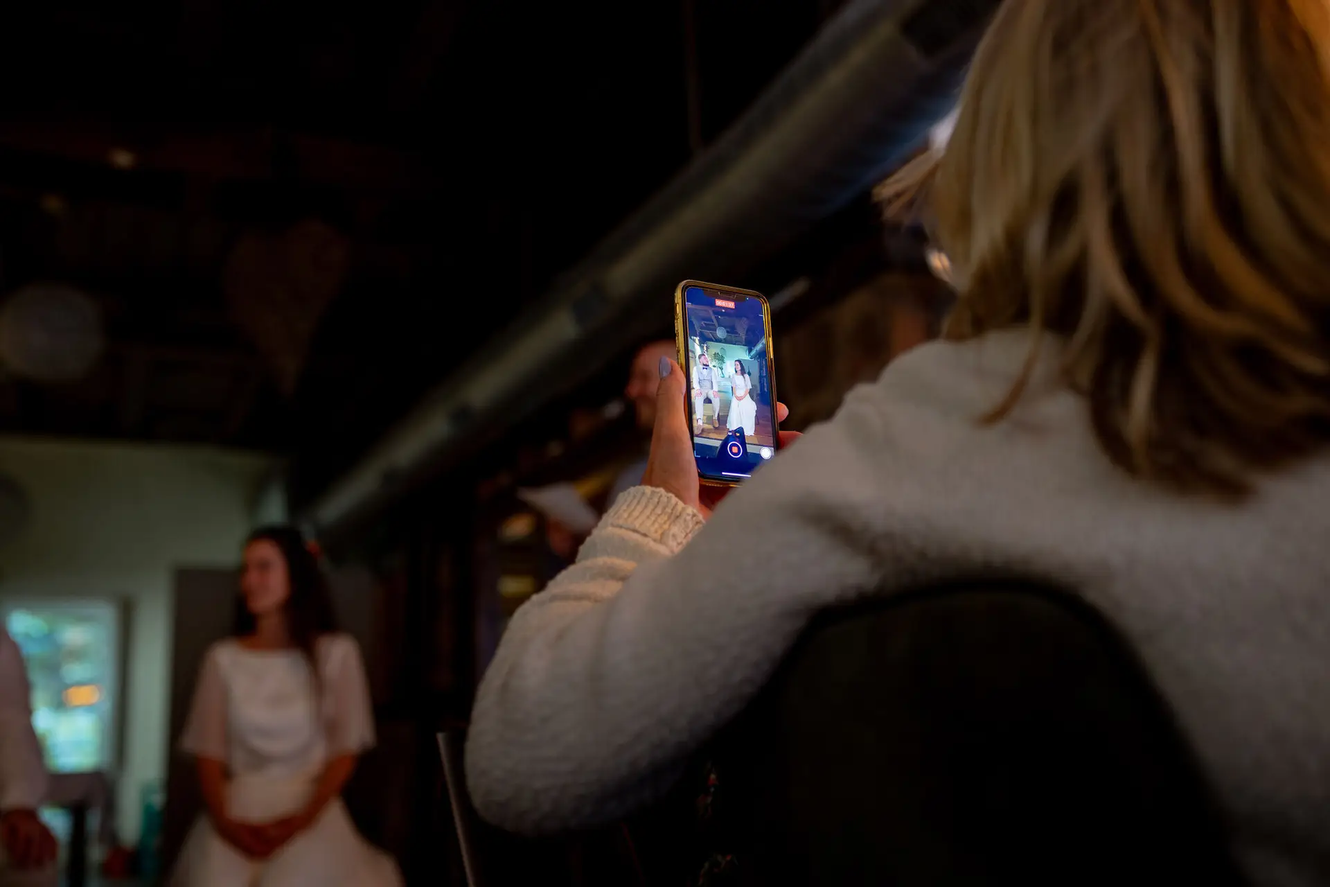 Gast filmt mit Smartphone einen besonderen Moment beim Abendessen – die Braut im Fokus