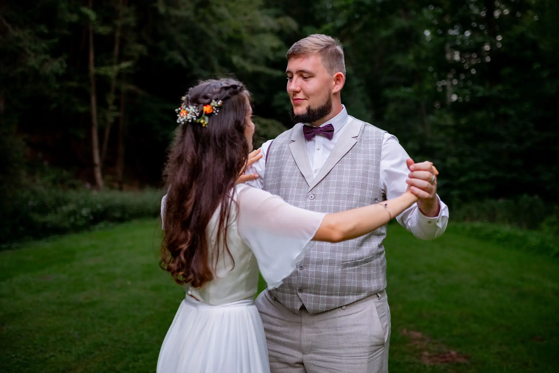 Brautpaar tanzt romantisch auf der abendlichen Wiese im Elztal, Blumen und Natur ringsum