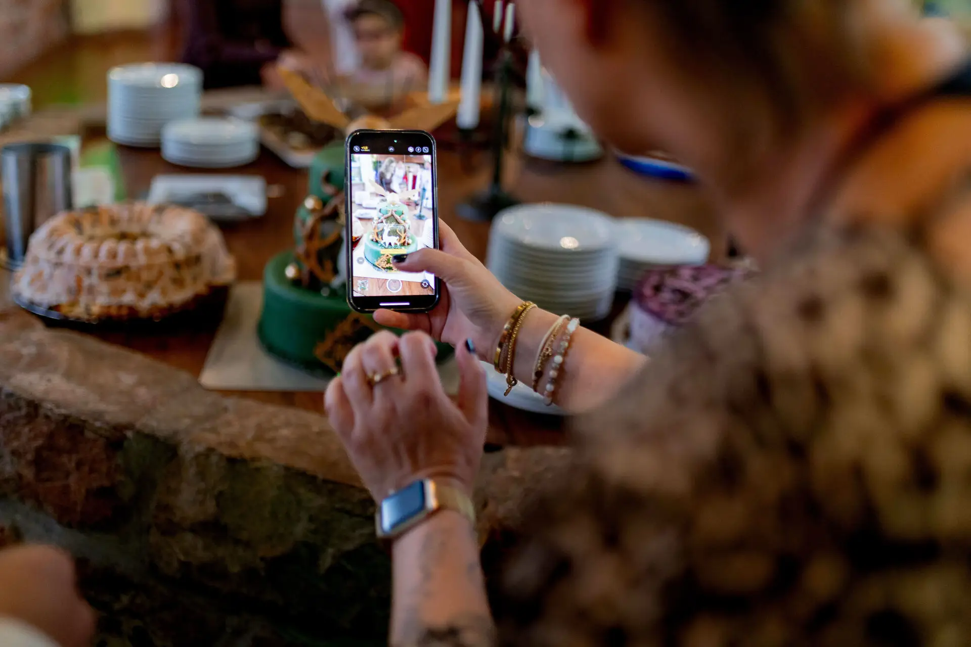 Gast fotografiert die Hochzeitstorte mit dem Smartphone